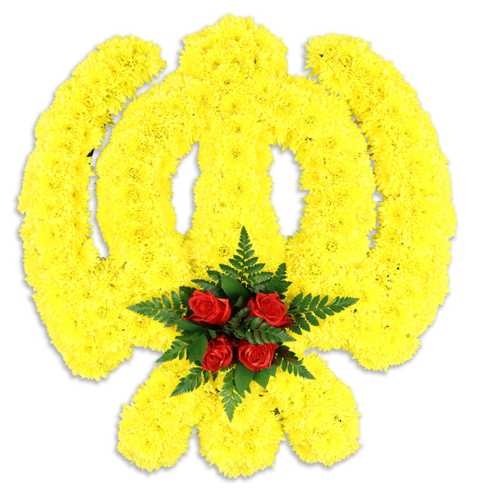 Set against a clean white background, this large floral Khanda commands attention through colour and careful construction: thousands of compact yellow chrysanthemum blooms have been arranged to outline the emblem's circular chakkar, the straight double-edged sword at its centre, and the two crossed kirpans below. The small, densely packed flowers create a continuous, sunlit field of yellow with a soft, pillowy texture that feels buoyant yet precise. At the heart of the symbol a cluster of five to six deep red roses is nestled on a bed of dark green fern fronds, their glossy leaves and rich crimson petals forming a solemn, contrasting nucleus. The roses' velvety surface reads as a point of quiet dignity against the surrounding glow of yellow, while the fern adds a cool, structured frame. Lighting is even and neutral, and a faint shadow beneath the piece suggests it is a freestanding memorial wreath or ceremonial floral sculpture intended for placement rather than vase display. The implied aroma is classic and measured - the sweet, faintly spicy scent of chrysanthemums blended with the deeper, more poignant fragrance of garden roses. Crafted with respect and technical skill, this floral Khanda exemplifies a tribute suitable for memorial services, religious observances, or civic commemorations in Leyton - imagine it placed in a community hall near Coronation Gardens or brought to a remembrance at a local gurdwara, carrying reassurance and reverence in equal measure.