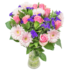 With inspiration drawn from Leyton's unique blend of tradition and vitality, this bouquet captures a sense of luminous beauty. Blush gerberas and classic pink roses meld seamlessly, forming a dreamy gradient like the dawn sky over Leyton Cricket Ground. Pops of deep purple statice break through the pastel cloud, adding playful rhythm and distinct texture. The cool sheen of fresh, local greenery grounds the composition, offering tactile freshness and the faint aroma of wild gardens you might stumble upon near Leyton Jubilee Park. Presented in a crystal-clear vase, the blooms take on an almost ethereal glow, inviting closer appreciation. Whether chosen as a cheerful get-well wish or a bright accent for a sun-filled Leyton flat, this bouquet speaks of meticulous craft and genuine joy in every detail, echoing the care and connection that define our local high street florists.